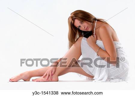 Stock Photo - Beautiful young woman in white summer dress. Fotosearch