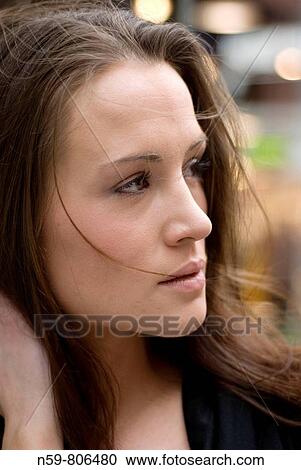 Beautiful young woman looking to her side View Large Photo Image Stock Image - Beautiful young woman looking to her side. Fotosearch