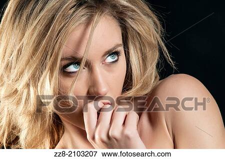 Stock Photo - Beautiful young woman looking up.. Fotosearch