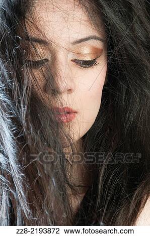 Beautiful young woman lost in thought. View Large Photo Image Stock Image - Beautiful young woman lost in thought.. Fotosearch
