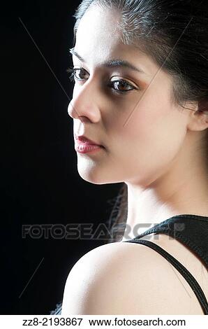 Beautiful young woman lost in thought. View Large Photo Image Stock Photo - Beautiful young woman lost in thought.. Fotosearch