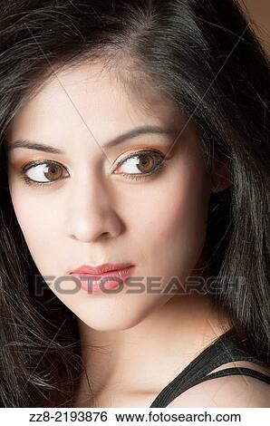 Beautiful young woman lost in thought. View Large Photo Image Stock Photograph - Beautiful young woman lost in thought.. Fotosearch