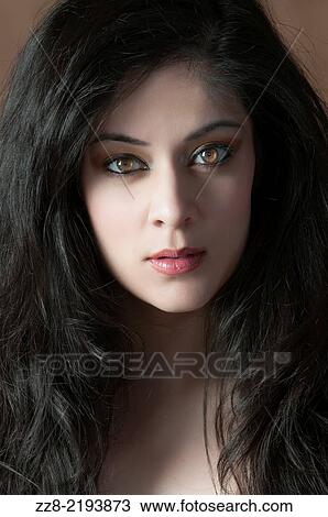 Stock Image - Beautiful young woman staring.. Fotosearch