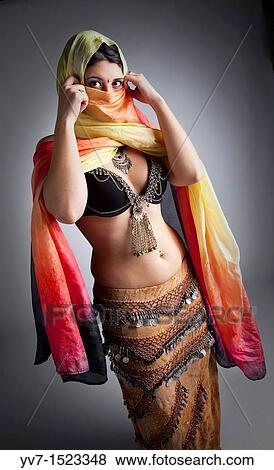 Stock Photo - Beautifull belly dancer with veil. Fotosearch