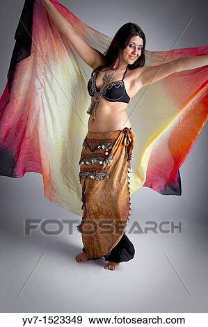 Stock Photo - Beautifull belly dancer with veil. Fotosearch