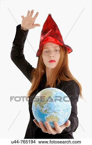Beautifull witch incantanting a global map View Large Photo Image Picture - Beautifull witch incantanting a global map. Fotosearch