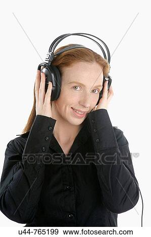 Beautifull woman hearing music on wired headphones View Large Photo Image Stock Photo - Beautifull woman hearing music on wired headphones. Fotosearch