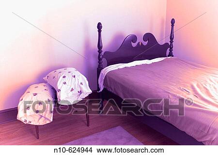 Bed and two pillows, setting on a night table, in a bedroom. View Large Photo Image Picture - Bed and two pillows, setting on a night table, in a bedroom.. Fotosearch