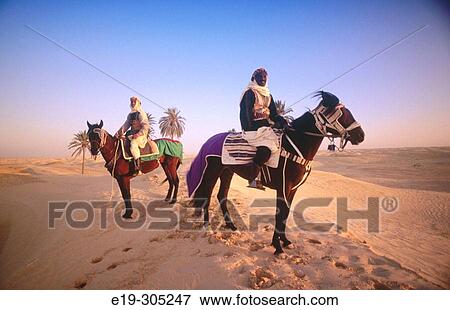 Bedouin horsemen. Tunisia View Large Photo Image Stock Photo - Bedouin horsemen. Tunisia. Fotosearch