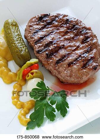 Beef burger with mustard and sour pickles View Large Photo Image Stock Photo - Beef burger with mustard and sour pickles. Fotosearch