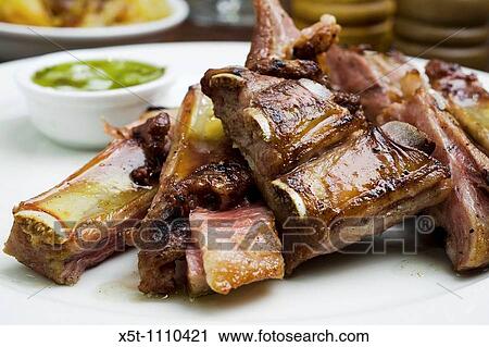 Stock Image - Beef rib Asado South American traditional dish in Argentina, Uruguay, Chile, and Paraguay. Fotosearch