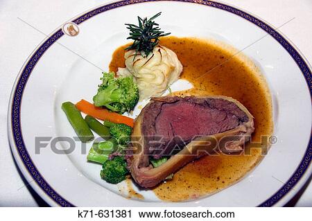Stock Image - Beef Wellington dinner with vegetables and duchess potatoes on the Holland America cruise ship Ryndam.. Fotosearch
