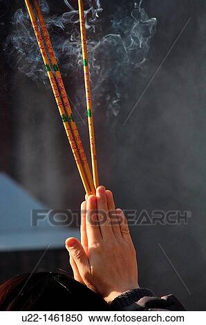 Beijing (China): a person prays burning incense at the Dongyue Temple during the Spring Festival View Large Photo Image Stock Image - Beijing (China): a person prays burning incense at the Dongyue Temple during the Spring Festival. Fotosearch