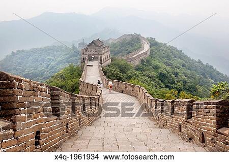 Beijing, China-August 17, 2010: Thousands of tourists visit daily the Chinese wall. A family walking on the Great Wall of China that the horizon is lost in the fog. View Large Photo Image Picture - Beijing, China-August 17, 2010: Thousands of tourists visit daily the Chinese wall. A family walking on the Great Wall of China that the horizon is lost in the fog.. Fotosearch