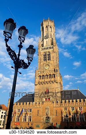 Stock Image - Belfry Tower in Market Square, in the medieval town of Brugge, listed World Heritage Site by UNESCO Flanders Belgium. Fotosearch