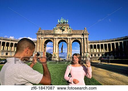 Stock Photo - Belgium Brussels Arch of Cinquatenaire colorful monument in Belgium with tourists and camera. Fotosearch