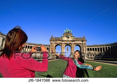 Stock Photo - Belgium Brussels Arch of Cinquatenaire colorful monument in Belgium with Chinese tourists and camera. Fotosearch