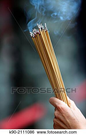 Believer holding insense sticks, Sik Sik Yuen Wong Tai Sin temple, Kowloon, Hong Kong, China, East Asia. View Large Photo Image Stock Photograph - Believer holding insense sticks, Sik Sik Yuen Wong Tai Sin temple, Kowloon, Hong Kong, China, East Asia.. Fotosearch