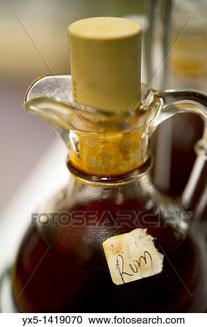 Stock Image - Bermudian black rum served as a spice for fish chowder soup. Fotosearch