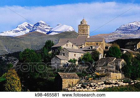 Stock Image - Bestu? village in front of tres Sorores massif (Monte Perdido-3355m. ). Escuain valley. Ordesa NP and Monte Perdido. Pyrenees. Huesca province. Aragon. Spain.. Fotosearch
