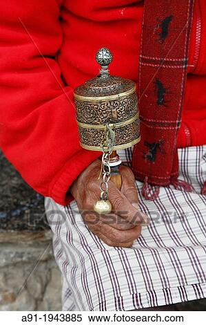Stock Photography - Bhutan (kingdom of), City of Thimphu, the Memorial buddhist chorten, old man with his portable prayers wheel. Fotosearch