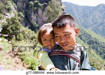 Bhutan. Paro. Bhutanese man with daughter. View Large Photo Image Picture - Bhutan. Paro. Bhutanese man with daughter.. Fotosearch