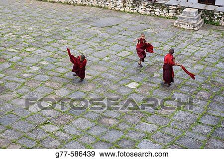 Bhutan. Paro. Paro Dzong Monastery. Little buddhist monks playing View Large Photo Image Stock Photo - Bhutan. Paro. Paro Dzong Monastery. Little buddhist monks playing. Fotosearch