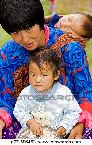 Bhutan. Thimpu. Thimpu Dzong Monastery. Buddhist Festival (Tsechu). Bhutanese woman with children View Large Photo Image Stock Image - Bhutan. Thimpu. Thimpu Dzong Monastery. Buddhist Festival (Tsechu). Bhutanese woman with children. Fotosearch
