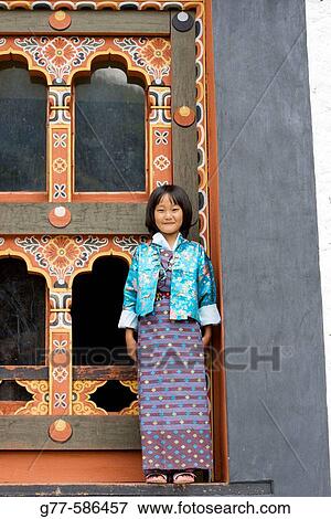 Stock Photo - Bhutan. Thimpu. Thimpu Dzong Monastery. Buddhist Festival (Tsechu). Bhutanese little girl.. Fotosearch