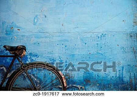 Bicycle parked against a blue wall Jodhpur, Rajasthan, India View Large Photo Image Stock Photo - Bicycle parked against a blue wall Jodhpur, Rajasthan, India. Fotosearch