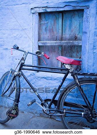Bicycle parked in front of blue painted wall in Jodhpur, Rajasthan, India. View Large Photo Image Stock Photograph - Bicycle parked in front of blue painted wall in Jodhpur, Rajasthan, India.. Fotosearch