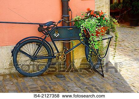 Stock Photo - Bicycle with Flowers in basket Rothenburg Germany DE Franconia Bavaria.. Fotosearch