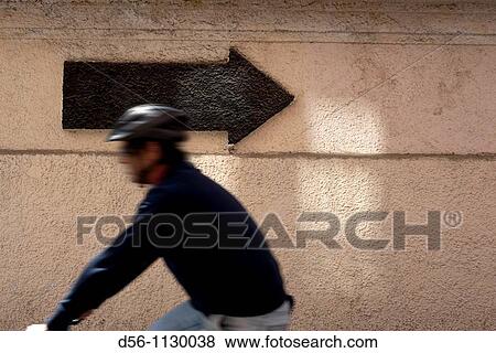 Stock Photo - Bicyclist and arrow, Valencia. Spain.. Fotosearch