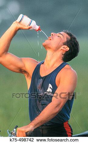 Bicyclist drinking water View Large Photo Image Stock Image - Bicyclist drinking water. Fotosearch
