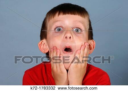Big blue eyes, open mouth, hands on cheeks, little boy View Large Photo Image Stock Image - Big blue eyes, open mouth, hands on cheeks, little boy. Fotosearch