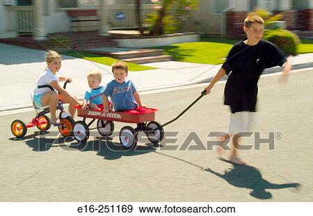 big brother pulling neighbors in wagon View Large Photo Image Stock Photo - big brother pulling neighbors in wagon. Fotosearch