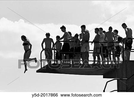 big group of men and boys watching the only female jumping from diving tower to waters of Lake Geneva, Paquis beach, Geneva, Switzerland. View Large Photo Image Stock Photograph - big group of men and boys watching the only female jumping from diving tower to waters of Lake Geneva, Paquis beach, Geneva, Switzerland.. Fotosearch