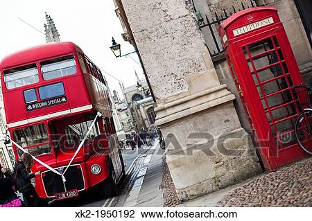Stock Image - Big red bus (marry) and typical telephone box in streets of Oxford, UK. Fotosearch