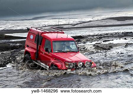 Big Red crossing the Tungnaa glacial river filled with ash from the Grimsvotn volcanic eruption, Iceland Eruption began on May 21, 2011 spewing tons of ash View Large Photo Image Stock Photograph - Big Red crossing the Tungnaa glacial river filled with ash from the Grimsvotn volcanic eruption, Iceland Eruption began on May 21, 2011 spewing tons of ash. Fotosearch