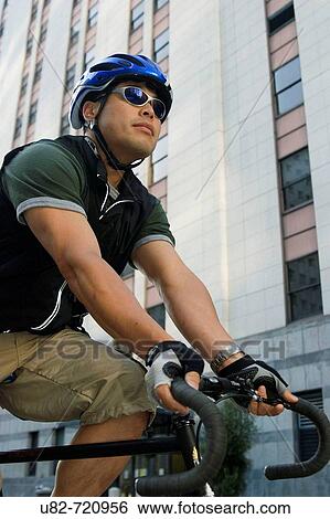 Stock Photograph - Bike messenger riding in the Financial District, San Francisco, California, USA. Fotosearch