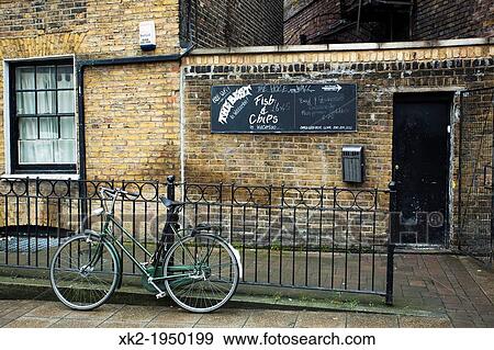 Stock Photo - Bike parked in front of a Fish and Chips, near waterloo, London, UK. Fotosearch