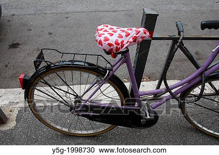 Stock Image - bike with red love hearts saddle in road street in rome italy.. Fotosearch