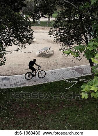 Biker at the old river bed Turia, Valencia, Spain View Large Photo Image Stock Photograph - Biker at the old river bed Turia, Valencia, Spain. Fotosearch