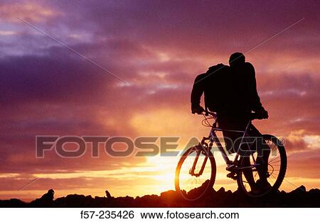 Biker contemplating a sunset View Large Photo Image Stock Photograph - Biker contemplating a sunset. Fotosearch