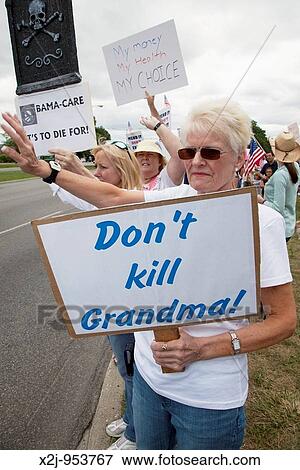 Birmingham, Michigan - People opposed to President Obama's proposals for health care reform line a highway an an affluent suburb of Detroit View Large Photo Image Stock Photo - Birmingham, Michigan - People opposed to President Obama's proposals for health care reform line a highway an an affluent suburb of Detroit. Fotosearch