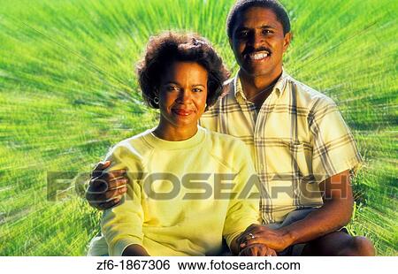 Stock Photograph - Black african american couple outdoors relaxing and having fun. Fotosearch