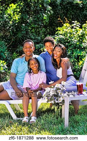 Stock Photo - Black african american family outside at home relaxing with caring and love lifestyle. Fotosearch