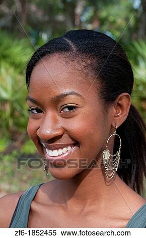 Black African American girl aged 18 portrait in yard outdoors laughing View Large Photo Image Stock Photography - Black African American girl aged 18 portrait in yard outdoors laughing. Fotosearch