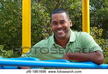 Black african american man aged 30s in park on playground portrait View Large Photo Image Stock Photograph - Black african american man aged 30s in park on playground portrait. Fotosearch