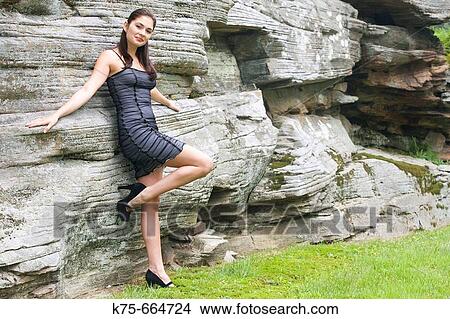 Black dress at stone wall View Large Photo Image Picture - Black dress at stone wall. Fotosearch